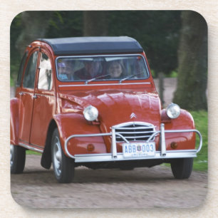 Ein altes rotes Citroen 2CV Auto mit einer lächeln Getränkeuntersetzer