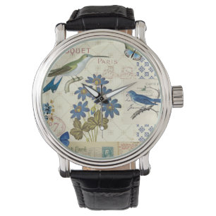 Ein Blumenstrauß der blauen Blumen, der Vögel un Armbanduhr