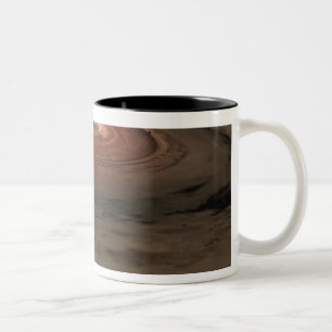 Ein brauner Zwerg umgeben durch eine wirbelnde Zweifarbige Tasse