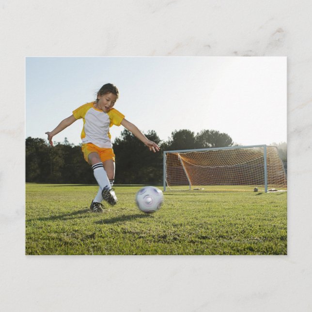 Ein junges Mädchen, das Fußball auf einem Fußballp Postkarte (Vorderseite)