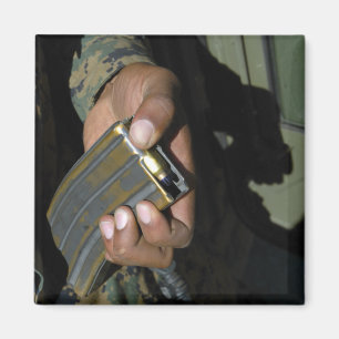 Ein Marinesoldat lädt leere Munitionsrunden Magnet