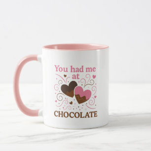Ein rosa und braunes Design Herzen mit einer süßen Tasse