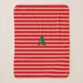 Ein rosafarbener Streifen mit nur einem Monogramm Sherpadecke