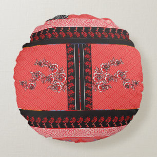 ein rotes und schwarzes Muster mit Blume darauf Rundes Kissen