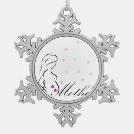Ein schwangeres Mutter-zu-ist mit rosa Schneeflocken Zinn-Ornament