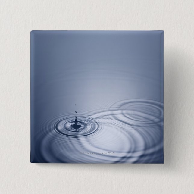 Ein Singletröpfchen des Wassers fallend in eine Button (Vorderseite)