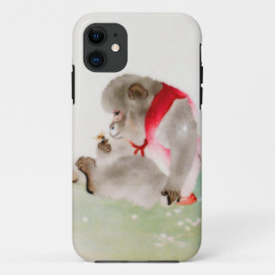Ein sitzender Affe, der ein Insekt beobachtet iPhone 11 Hülle