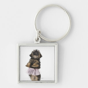 Ein Yorkie-poo Welpe in einem Ballettröckchen auf Schlüsselanhänger
