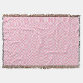 Eine dekorative rosa Wurfdecke mit einem subtilen Decke