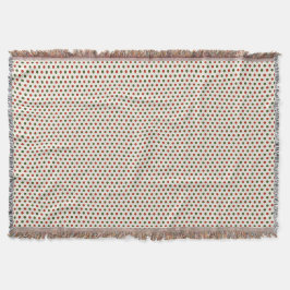 Eine gewebte Decke mit roten und grünen Tupfen