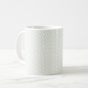 Eine Streuung von hellgrünen Quadraten auf Weiß. Kaffeetasse
