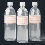 Einfache Elegant Flourish Blush Pink & Gold Weddin<br><div class="desc">These beautiful water bottle labels will make your wedding celebration all the more special. They Feature hat einfach yet elegant design with gold script lettering on blush pink background with a vintage gold filigree floral border. There are spaces to enter the wedding paar Names as well as the wedding datiert....</div>