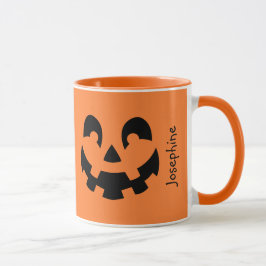 Einfache schwarze Kürbisgesicht an orangefarbenem Tasse