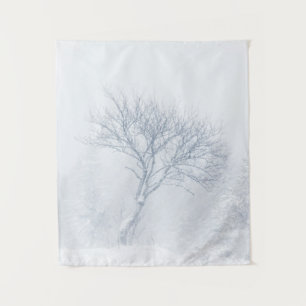 Einsamer Baum bei Schneesturm im Winter Wandteppich