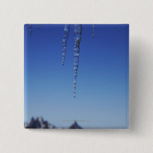 Eiszapfen und schneebedeckte Berge Button