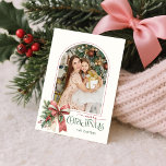 Elegant Coquette Bow Merry Christmas Arch Photo Feiertagskarte<br><div class="desc">This charming holiday greeting features an elegant arch shaped photo template with thin pink border, sweet watercolor blush pink and ecru bow with holly and winter greenery, custom Merry Christmas text graphic in coordinating colors and text fields on a light ecru background. The back features a coordinating blush pink watercolor...</div>