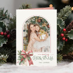 Elegant Coquette Bow Merry Christmas Arch Photo Feiertagskarte<br><div class="desc">This charming holiday greeting features an elegant arch shaped photo template with thin pink border, sweet watercolor blush pink and ecru coquette style bow with holly and winter greenery and custom Merry Christmas text graphic in coordinating pink and sage green colors. The inside features additional text fields, complementary bow with...</div>