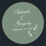 Elegant Formal Sage Olive Green Script Wedding Runder Aufkleber<br><div class="desc">Eine schöne elegante Schrift Typografie Hochzeitsdesign mit einem schlauen olivgrüne Hintergrund Farbe. Ein einzigartiges Design, das einen persönlichen klassischen Kalligraphie Hochzeitsladen Schriftart und einen handgezeichneten grünen Blattzweig verwendet. Ein formelles Skript Kalligrafie-Design mit Tönen von Salbei Oliven grün. Ein elegantes Hochzeitsaufkleber-Design mit klassischen traditionellen Elementen. Auch die passenden Hochzeitseinladungen und andere...</div>