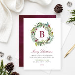 Elegant Winter Greenery Burgundy Monogram Wreath Feiertagskarte<br><div class="desc">This elegant and minimal Christmas card features a floral greenery watercolor wreath design framing a custom burgundy / wine red monogram initial along with stylish burgundy red, green, and dark gray text that can be fully personalized with your "Merry Christmas" holiday greeting, family member names, and the year. A coordinating...</div>