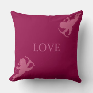 Elegante Cupiden in Rose Gold auf Bordeaux Kissen