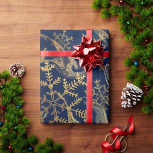 Elegante Schneeflocken aus Kupfergold in blauer Ma Geschenkpapier