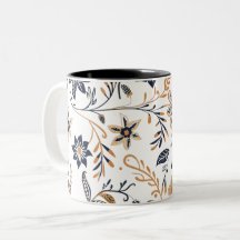 Eleganter blauer und goldener Blumenmuster-Becher