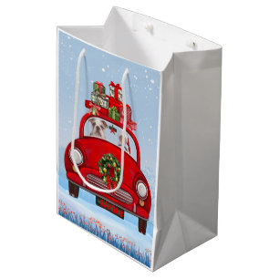 Englische Bulldogge im Auto mit dem Weihnachtsmann Mittlere Geschenktüte