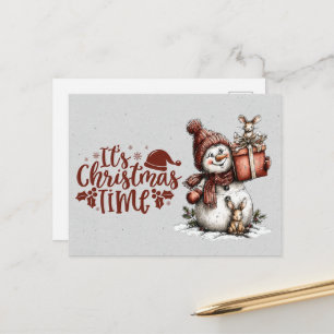 Es ist Weihnachtszeit Schneemann hält Geschenk und Postkarte
