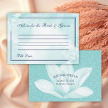 Ethereal Crystal Blue Magnolia , Hochzeit Hinweiskarte<br><div class="desc">Hochzeitsratenkarte mit einer zarten, kristallblauen Magnolia-Blume über einem abstrakten, blumengeschmückten Hintergrund im selben Stil und dem Titel: "Ratschlag für Braut und Bräutigam" in einem eleganten Kalligraphieskript, umgeben von zwei dünnen Rändern. Auf der Rückseite sind Ihre Namen , Datum, Stadt und Staat über einen Imitat Glitzer Hintergrund und eine kristallblaue Magnolia...</div>