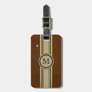 Étiquette À Bagage monogramme pour identifier une valise brune.