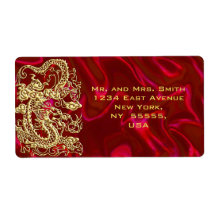 Dragon d'or embouti sur papier satin rouge