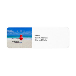 Étiquette Life Begins at Retirement, frosty drink on beach