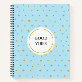 Étoiles dorées sur cahier bleu turquoise clair