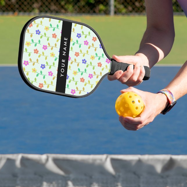 Farbenfrohe Blume, hellgrüner Hintergrund, schwarz Pickleball Schläger (InSitu)