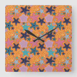 Farbenfrohe Starfische mit orangefarbenem Hintergr Quadratische Wanduhr