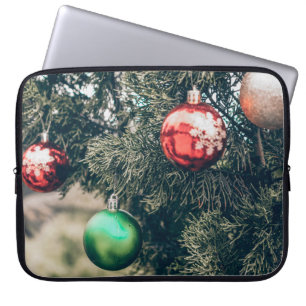 Farbenfrohe Weihnachtsbaumdekoration auf einem Bau Laptopschutzhülle
