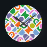 Farbige geometrische Formen Runde Wanduhr<br><div class="desc">A colorful and modern design that feature geometric cut-out shapes. This playful design is inspirred by retro, mid-century modern style and would be great for the modern home, rec, playroom or kid's room. Colors included in this abstract pattern are; blue, purple, pink, green, yellow, pink and orange against a white...</div>