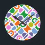 Farbige geometrische Formen Runde Wanduhr<br><div class="desc">A colorful and modern design that feature geometric cut-out shapes. This playful design is inspirred by retro, mid-century modern style and would be great for the modern home, rec, playroom or kid's room. Colors included in this abstract pattern are; blue, purple, pink, green, yellow, pink and orange against a white...</div>