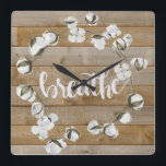 Farmhouse Inspiration - Breathe Quadratische Wanduhr<br><div class="desc">Farmhouse Inspiration II by Jennifer Paxton Parker. Features the word "Breathe" in cursive alongside a cotton wreath and wood plank background.</div>