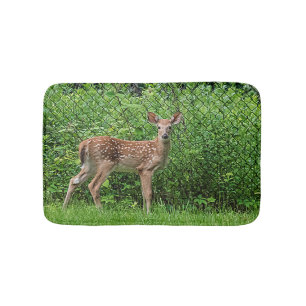 Fawn vor einem Zaun Badematte