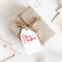 Feierliche rote Skripte frohe Weihnachten zu und v Geschenkanhänger