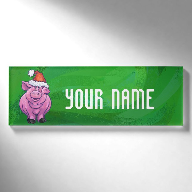 Feierliches Schwein in Weihnachtsmannmütze auf Grü Namenschild (Vorderseite)