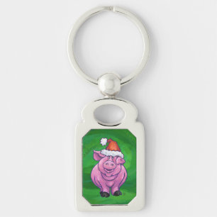 Feierliches Schwein in Weihnachtsmannmütze auf Grü Schlüsselanhänger