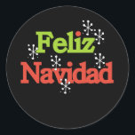 Feliz Navidad Merry Christmas Runder Aufkleber<br><div class="desc">Roter und grüner Text mit weißen Schneeflocken lautet "Feliz Navidad" auf den Urlaubskarten,  Tasse,  Taschen,  Tasten,  T - Shirt und vielem mehr.</div>