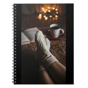 Feminine feet wrapped in soft, fluffy socks , with notizblock
