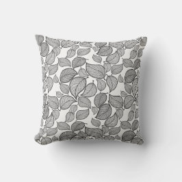 Feuilles noirs sur oreiller blanc