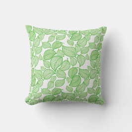 Feuilles verts sur oreiller blanc
