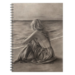 Fille au carnet de plage