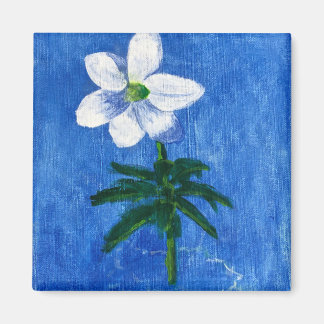 fleur blanche sur aimant de peinture bleue