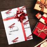 Flying Airplane, the First Christmas Personalisier Geschenkpapier<br><div class="desc">Design zeigt Santa Fliegen als Pilot in einem roten Flugzeug mit einem Namen Banner. Banner können mit dem Namen Ihres Kindes,  der ersten Weihnachtszeit und dem Jahrestext angepasst werden. Das wäre perfekt für diesen kleinen Aviator! Copyright steigt in Style Designs LLC.</div>